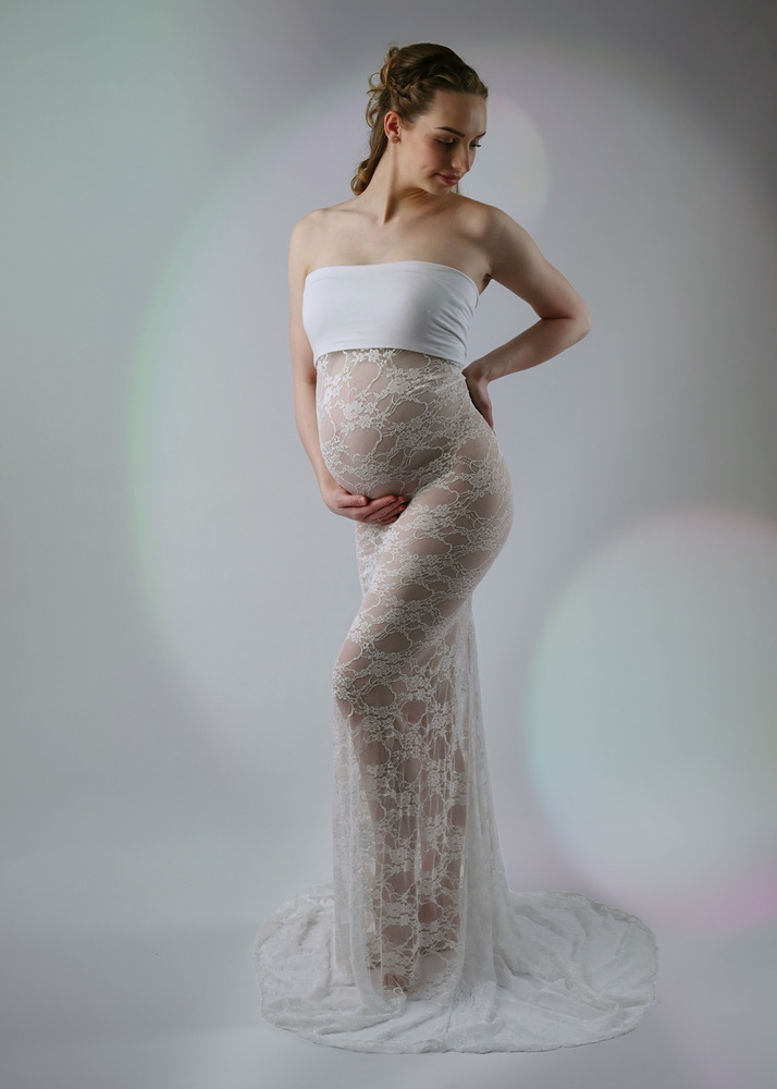 Wunderschöne Babybauch Fotografie im Studio und outdoor Eine werdende Mutter liebevoll dargestellt mit Ihrem Babybauch im warmen Studiolicht
